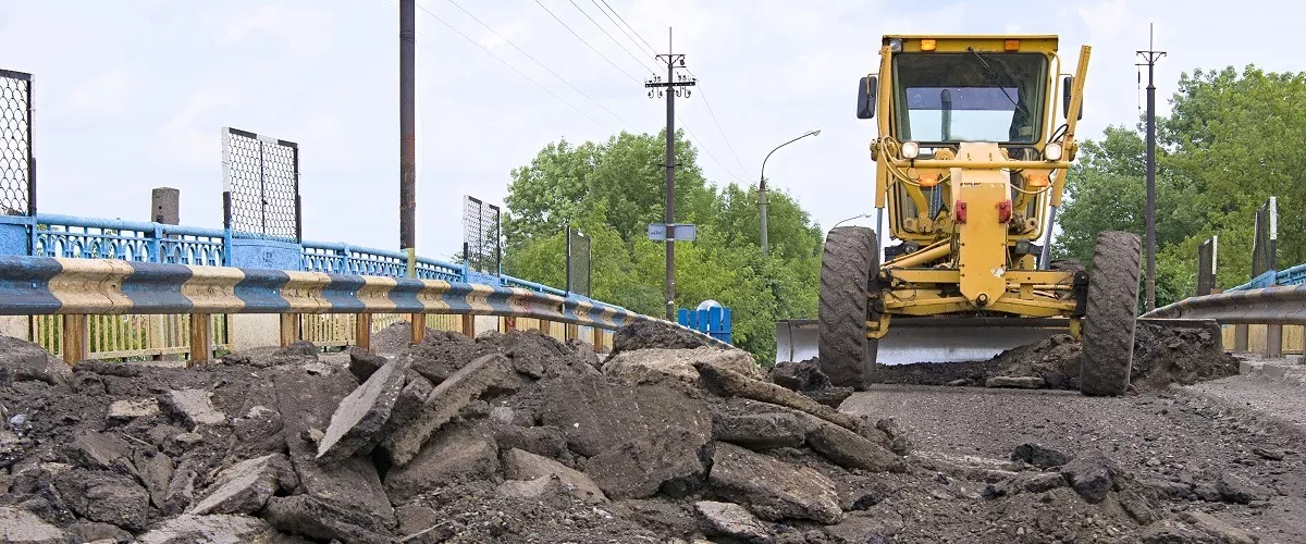 Heavy equipment remodeling a road