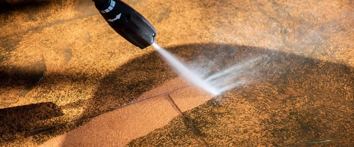 Using pressure washer to clean the driveways
