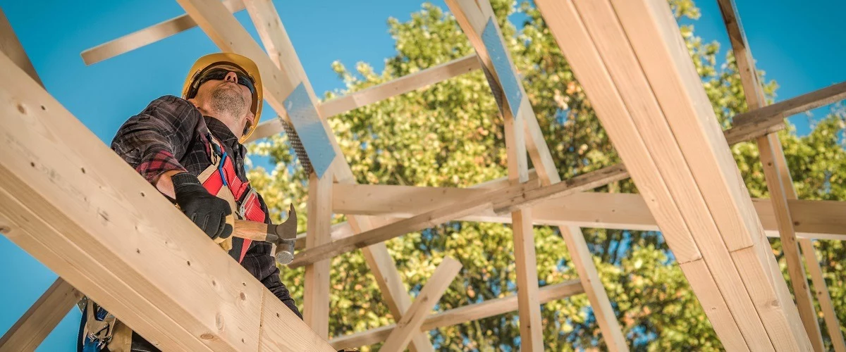 Contractor on top of roof frame