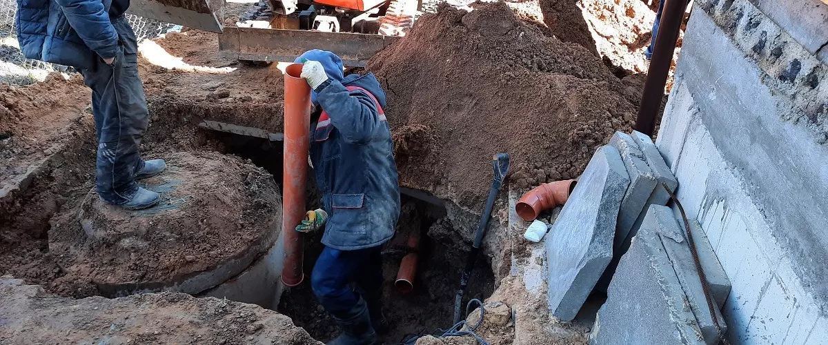 Contractors plowing for sewer construction