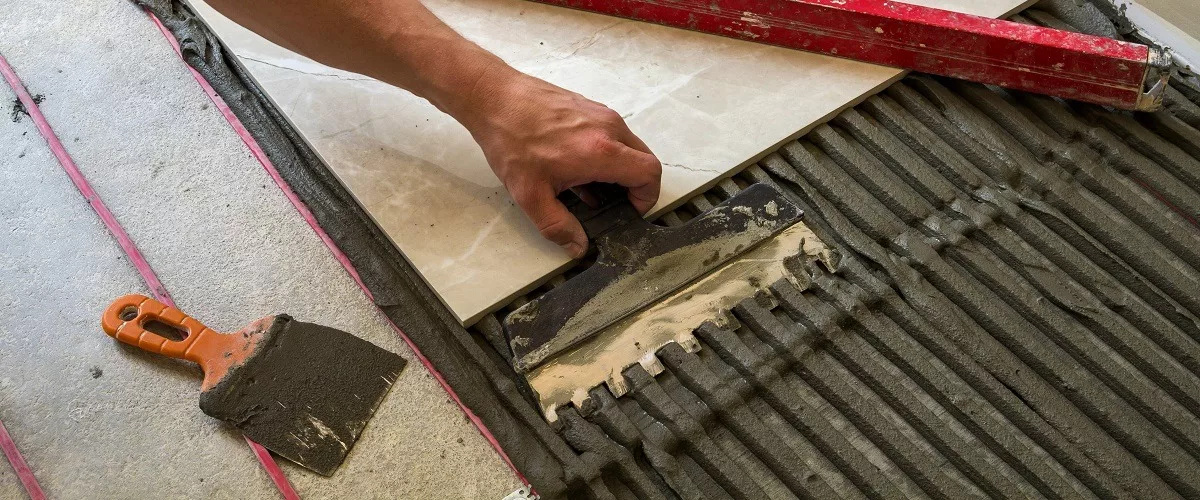 Contractor putting concrete to install tiles or marbles